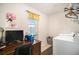 Laundry room features a desk workspace and a full-size washer and dryer at 7787 Richmond Trl, Fairburn, GA 30213
