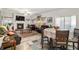 Open concept living and dining space with hardwood floors and fireplace at 7787 Richmond Trl, Fairburn, GA 30213