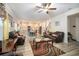 Open living room with kitchen view, hardwood floors, and comfy seating at 7787 Richmond Trl, Fairburn, GA 30213