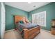 Bedroom with wood bed frame and teal colored walls at 1340 Cascade Falls Sw Dr, Atlanta, GA 30311