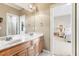 Double vanity bathroom with light wood cabinets and a view into a bedroom at 2041 Democracy Dr, Buford, GA 30519