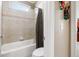 Bright bathroom with shower/tub combo, toilet and tile surround at 2041 Democracy Dr, Buford, GA 30519