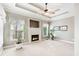 Living room with fireplace, large windows, and neutral color palette at 2041 Democracy Dr, Buford, GA 30519