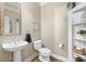 Convenient powder room with pedestal sink and white toilet at 2041 Democracy Dr, Buford, GA 30519