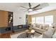 Comfortable living area with a decorative fireplace, a contemporary ceiling fan, and natural light at 2191 Essex Sw Ave, Atlanta, GA 30311