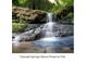 Beautiful waterfall flowing over rocks in Cascade Springs Nature Preserve at 2191 Essex Sw Ave, Atlanta, GA 30311