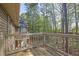 Spacious wooden back deck with railing offers a serene view of the surrounding trees at 2707 Country Park Se Dr, Smyrna, GA 30080