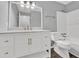 Modern bathroom boasts a white vanity with gold hardware and a combined shower and tub at 2707 Country Park Se Dr, Smyrna, GA 30080