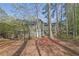 Exterior view of a house with a multi-tiered deck surrounded by lush trees and landscaping at 2707 Country Park Se Dr, Smyrna, GA 30080