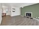 Bright living room featuring a fireplace and new flooring with views into the dining area and kitchen at 2707 Country Park Se Dr, Smyrna, GA 30080