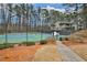 Community tennis courts surrounded by trees and shrubbery offer a great recreational space at 2707 Country Park Se Dr, Smyrna, GA 30080