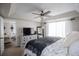 Spacious Primary bedroom with ceiling fan, TV, and an open doorway to another room at 706 Berry Ct, Villa Rica, GA 30180