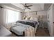 Bright primary bedroom boasts tray ceilings, a ceiling fan, and a serene atmosphere at 706 Berry Ct, Villa Rica, GA 30180