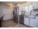 Modern kitchen with stainless steel appliances, white cabinets, and a farmhouse sink, combining style and functionality at 706 Berry Ct, Villa Rica, GA 30180