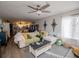 Spacious living room with hardwood floors, cozy furniture, and large windows, creating a welcoming and comfortable atmosphere at 706 Berry Ct, Villa Rica, GA 30180