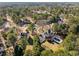 Aerial view of the property showcases the pool, deck, lush greenery, and neighborhood at 125 Hillcrest Trce, Fayetteville, GA 30215