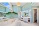 Bright and stylish bathroom with jetted tub, vanity, and a view of the sky through a window at 125 Hillcrest Trce, Fayetteville, GA 30215