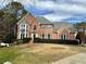 Brick house with gray roof, landscaping, and a well-manicured lawn at 125 Hillcrest Trce, Fayetteville, GA 30215