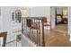 Elegant foyer featuring hardwood floors, stylish railing, and an eye-catching chandelier at 125 Hillcrest Trce, Fayetteville, GA 30215
