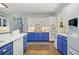 Modern kitchen with blue and white cabinets and hardwood floors at 125 Hillcrest Trce, Fayetteville, GA 30215