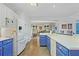 Spacious kitchen with white and blue cabinets and hardwood floors at 125 Hillcrest Trce, Fayetteville, GA 30215