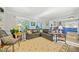 Open-concept living room with hardwood floors, built-ins, and a view of the connected kitchen at 125 Hillcrest Trce, Fayetteville, GA 30215