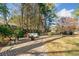 Brick patio with fire pit and seating area, surrounded by trees at 125 Hillcrest Trce, Fayetteville, GA 30215