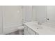 Bathroom with a large mirror, a sink with a white cabinet, and a tub with tile at 3330 Hillshire Dr, Cumming, GA 30028