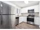 Modern kitchen features stainless steel appliances and granite countertops at 5632 Rock Springs Rd, Lithonia, GA 30038