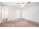 Spacious main bedroom with ceiling fan and access to bathroom at 5632 Rock Springs Rd, Lithonia, GA 30038