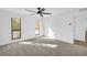 Light-filled bedroom with neutral carpeting and access to hallway at 1608 Woodcliff Ne Dr, Atlanta, GA 30350