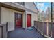 Red door entry to the townhouse with a deck at 1608 Woodcliff Ne Dr, Atlanta, GA 30350