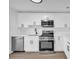 Modern white kitchen with stainless steel appliances at 1608 Woodcliff Ne Dr, Atlanta, GA 30350