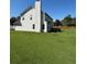 Back of the house with a large yard surrounded by a wood fence at 575 Dunagan Dr, Lawrenceville, GA 30045