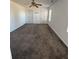 Spacious bedroom featuring a ceiling fan, two windows, and carpeted flooring at 575 Dunagan Dr, Lawrenceville, GA 30045