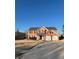 Well-maintained two-story home with a two-car garage, manicured lawn, and a long driveway at 575 Dunagan Dr, Lawrenceville, GA 30045