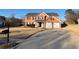 Two-story brick home featuring an attached two-car garage and well-manicured landscaping at 575 Dunagan Dr, Lawrenceville, GA 30045