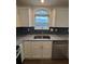 Kitchen features stainless steel appliances, granite countertops and window at 575 Dunagan Dr, Lawrenceville, GA 30045