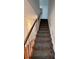 Carpeted staircase with white railings and wood accents at 575 Dunagan Dr, Lawrenceville, GA 30045