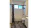 Clean bathroom with tub, toilet and wood-look floor at 575 Dunagan Drive, Lawrenceville, GA 30045