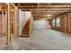 Unfinished basement with wooden staircase and exposed framing ready to be transformed into a livable space at 4002 Adler Cir, Buford, GA 30519