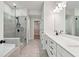Luxurious bathroom featuring a double vanity, soaking tub, and a glass-enclosed shower at 4002 Adler Cir, Buford, GA 30519