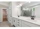 Well-lit bathroom featuring a double vanity, walk-in closet, and glass-enclosed shower at 4002 Adler Cir, Buford, GA 30519