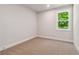 Cozy bedroom with carpet, natural light, and a peaceful view of the trees at 4002 Adler Cir, Buford, GA 30519