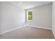 Bright bedroom with neutral carpet and a large window at 4002 Adler Cir, Buford, GA 30519