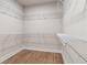 Bright walk-in closet features white shelving with plenty of space for optimal organization at 4002 Adler Cir, Buford, GA 30519