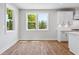 Bright dining area featuring hardwood floors, two windows and crisp white trim details at 4002 Adler Cir, Buford, GA 30519