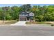 Charming two-story home featuring stone and siding exterior, manicured lawn and attached two-car garage at 4002 Adler Cir, Buford, GA 30519