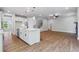 Open concept kitchen featuring a large island, stainless steel appliances, and hardwood floors at 4002 Adler Cir, Buford, GA 30519