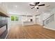 Bright open-concept kitchen with stainless appliances, island and hardwood floors at 4002 Adler Cir, Buford, GA 30519